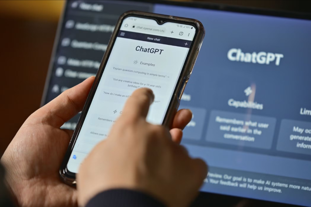 Close-up of a teen holding a phone open to the ChatGPT app |  www.imperiumtimes.com | @imperiumtimesofficial